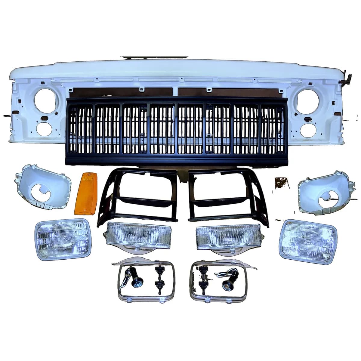 1991-1996 Cherokee XJ Black; Includes: Header Panel Headlamps Bulbs Bezels Adjusters Parking Lamps Sidemarker Lamps Grilles Headlamp Seats Headlamp Rings and all hardware